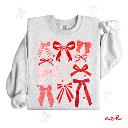 Gray sweatshirt with red bow designs on a white background