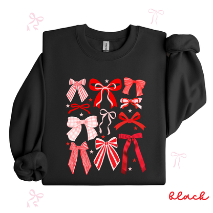 Black sweatshirt with red and pink bow designs on a white background