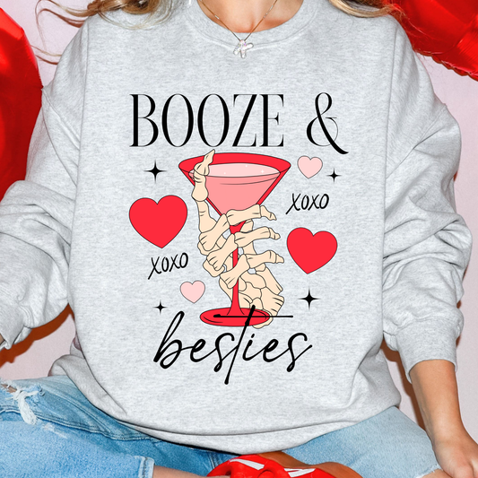 Gray sweatshirt with skeleton hand holding a cocktail and text 'BOOZE & besties' on a red heart background.