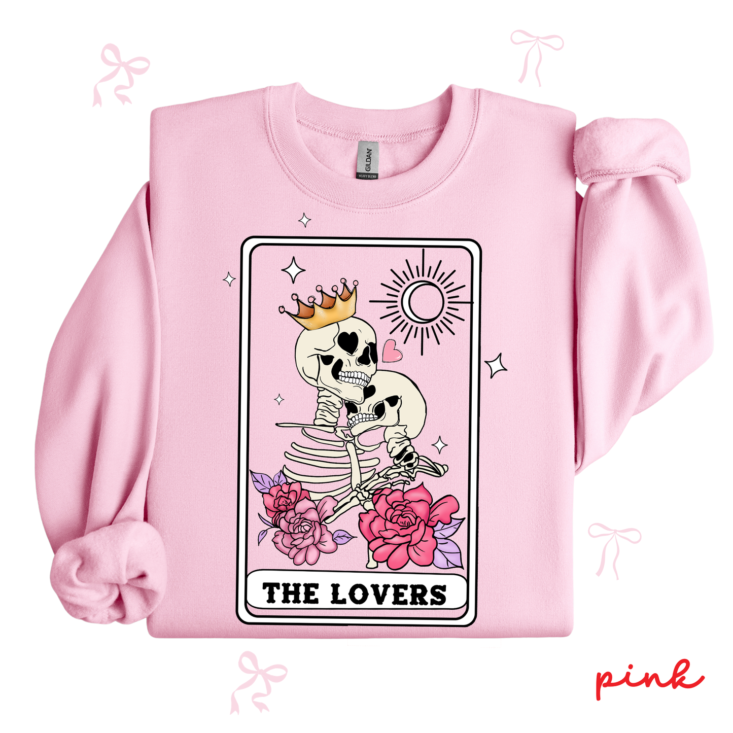 Pink sweatshirt with a tarot card design featuring a skeleton and flowers, labeled 'The Lovers'.