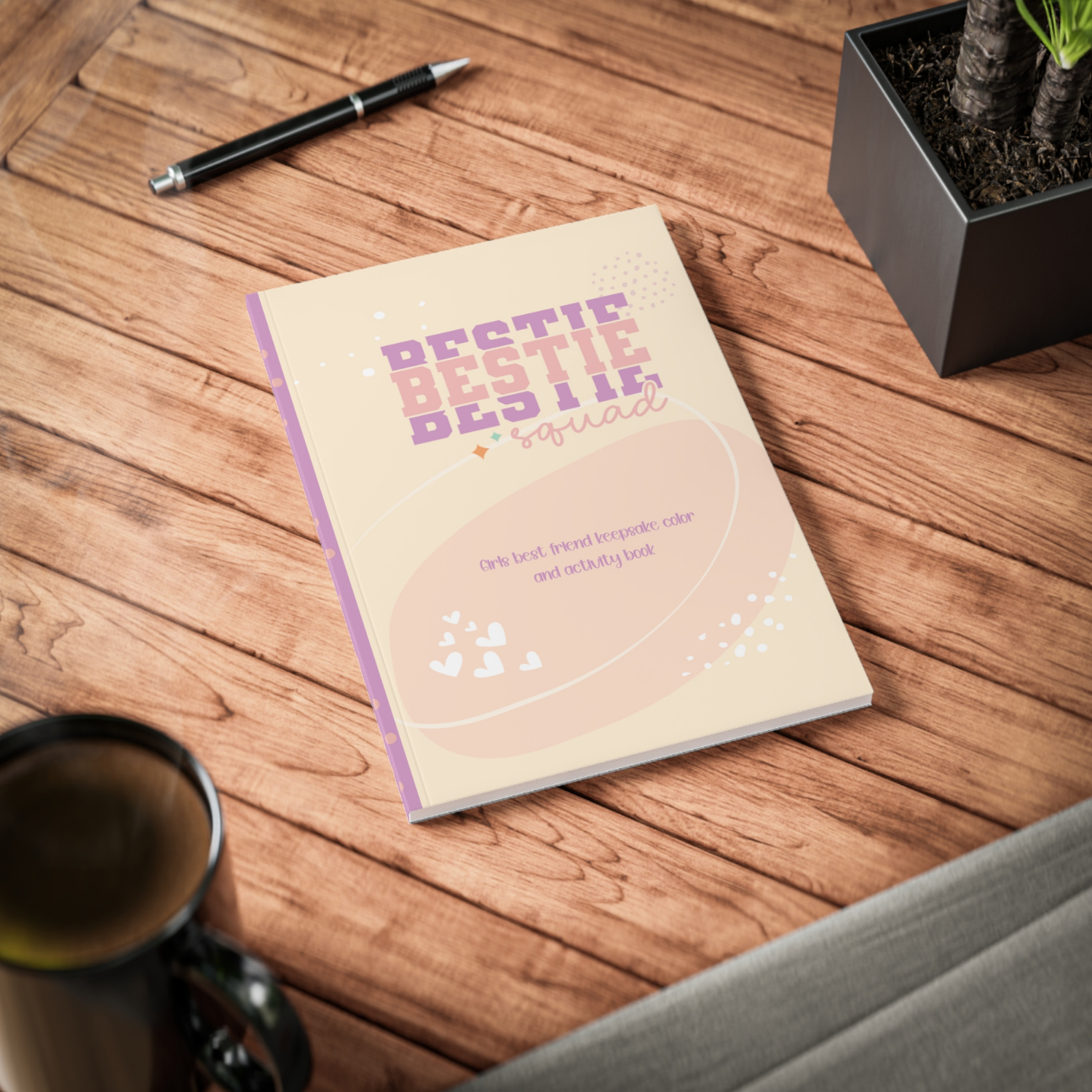 Notebook titled 'Bestie Bestie Squad' on a wooden surface with a pen and mug.