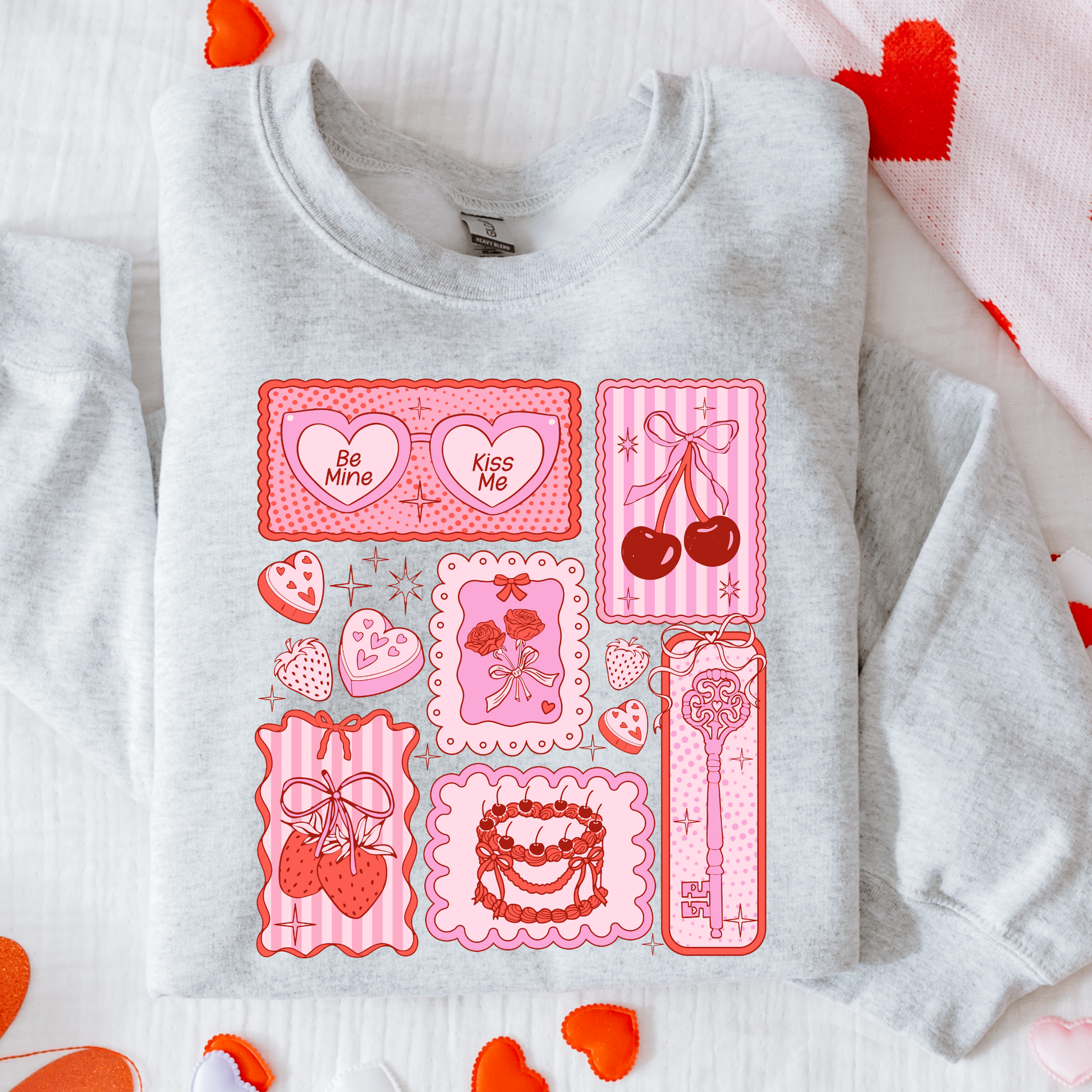 Gray sweatshirt with pink graphic designs on a white background