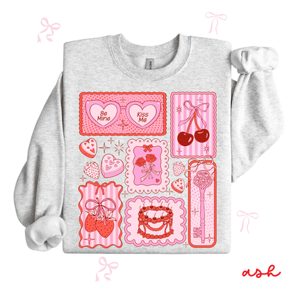 Gray sweatshirt with pink graphic designs on a white background