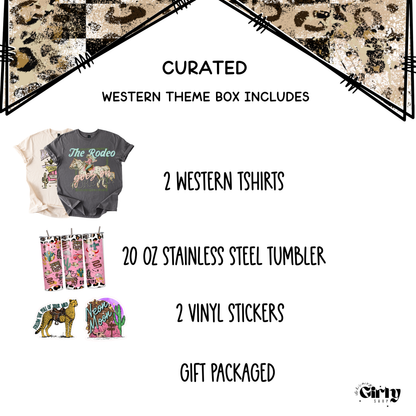Curated western-themed product box with t-shirts, tumbler, and stickers on a white background.