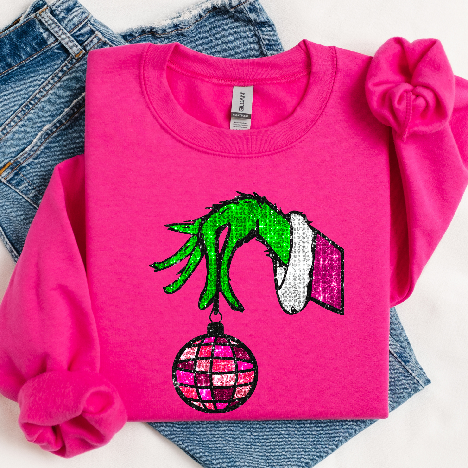 Pink sweatshirt with Grinch hand design on a white background