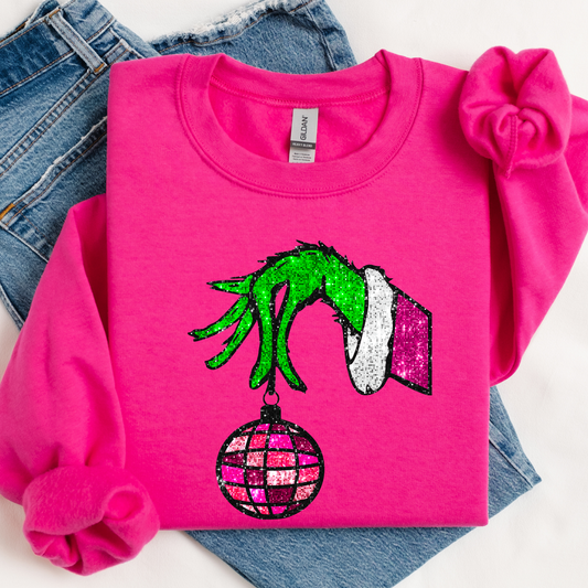 Pink sweatshirt with Grinch hand design on a white background