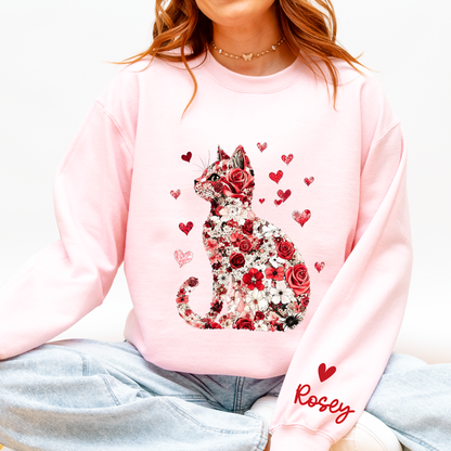 Person wearing a pink sweatshirt with a floral cat design and 'Rosely' text.