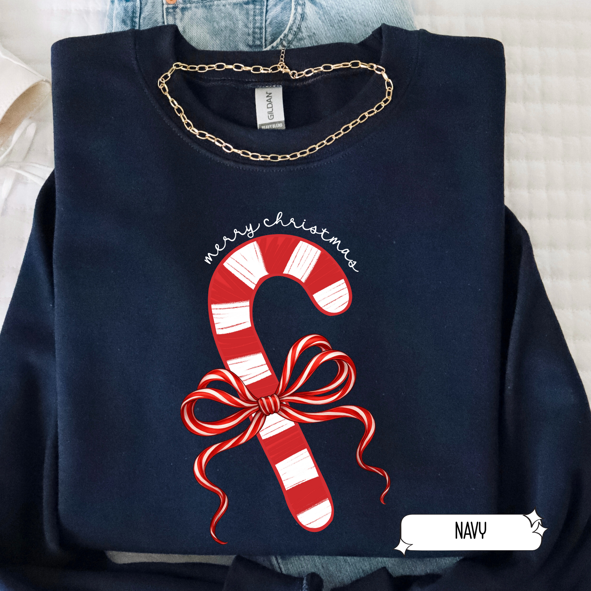 Navy sweatshirt with candy cane design and 'Merry Christmas' text on a light background