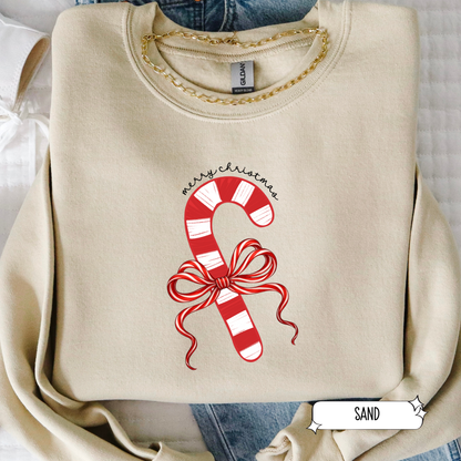 Beige sweatshirt with candy cane design and 'Merry Christmas' text on a white background
