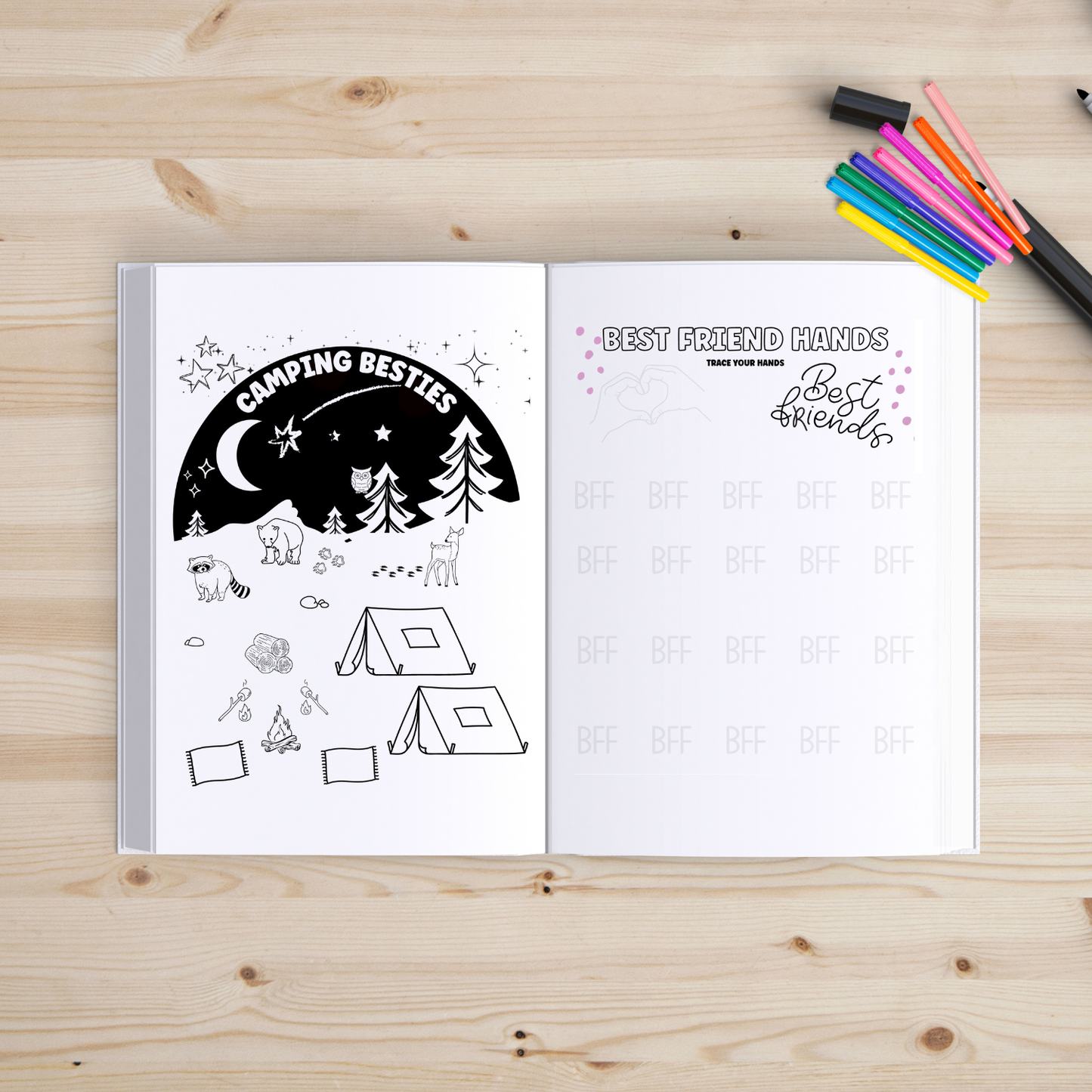 Open book with coloring pages on a wooden surface with markers.