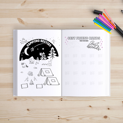 Open book with coloring pages on a wooden surface with markers.