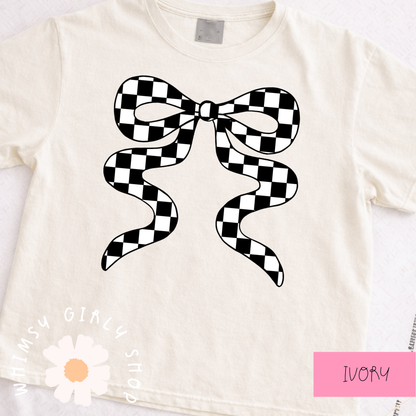 ivory t-shirt with a black and white checkered bow design on a white background