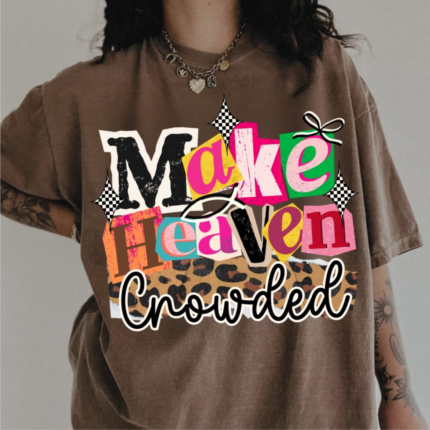 Brown t-shirt with colorful graphic text 'Make Heaven Crowded' on a plain background