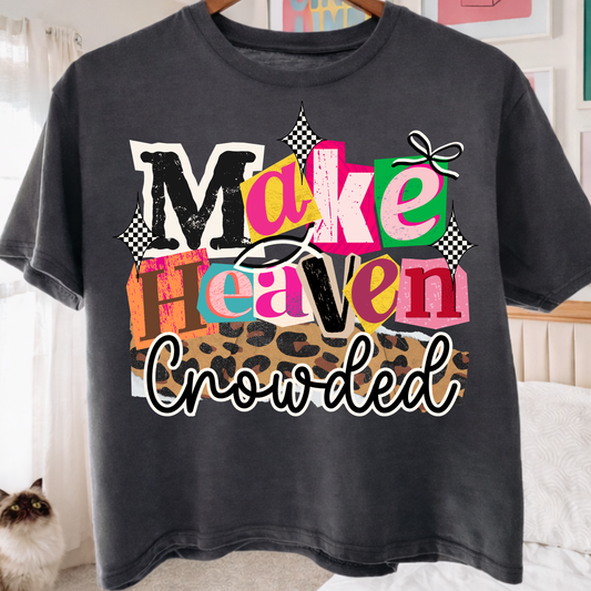 Black t-shirt with colorful text 'Make Heaven Crowded' in a casual setting.