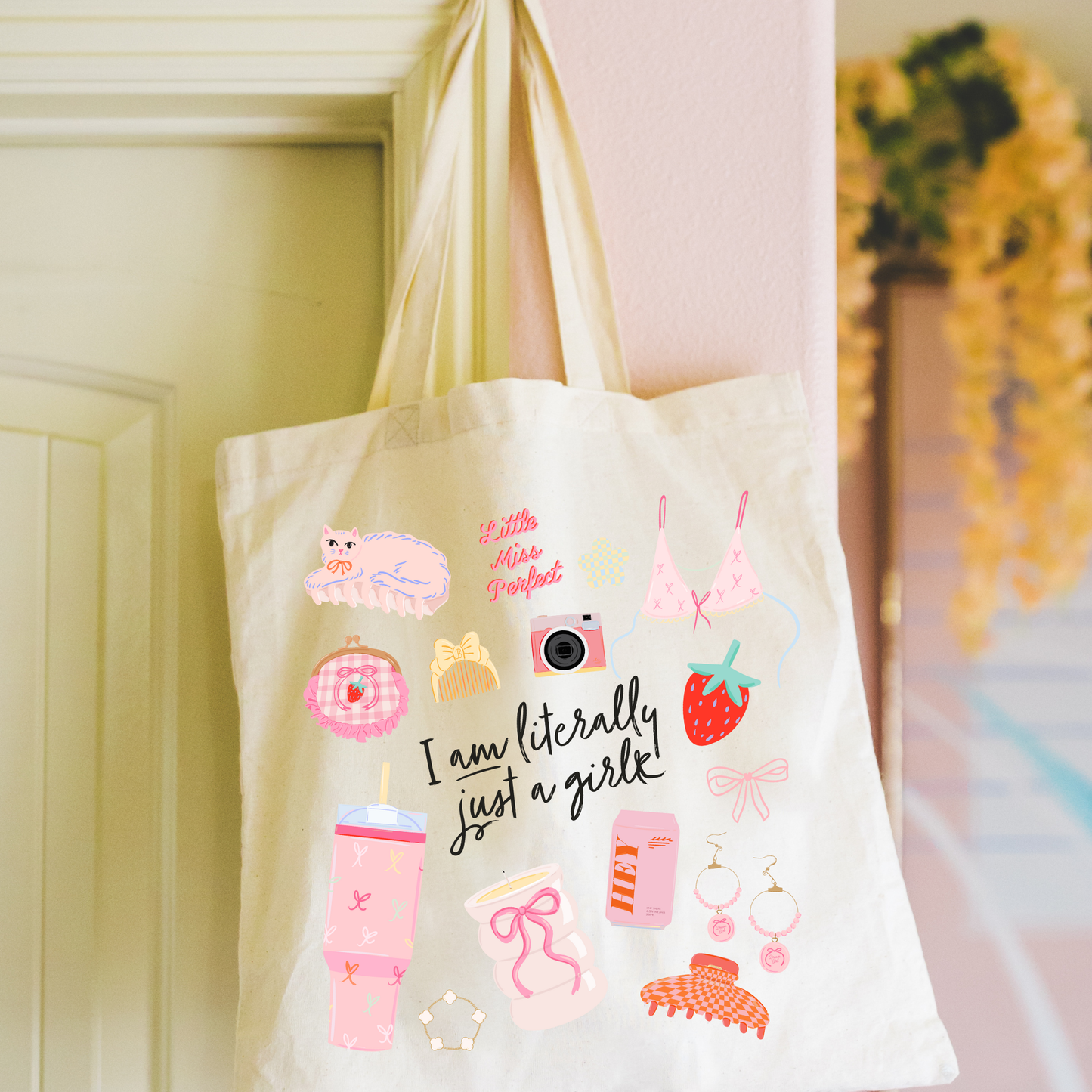girly tote hanging from door that says literally just a girl