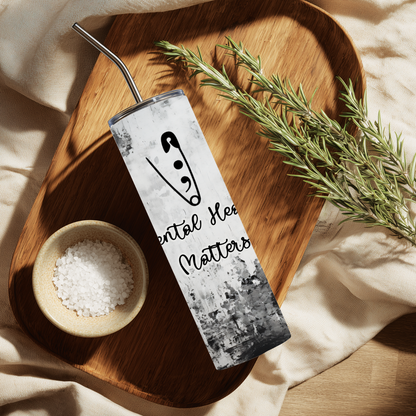 Tumbler with motivational quote on a wooden tray with salt and rosemary