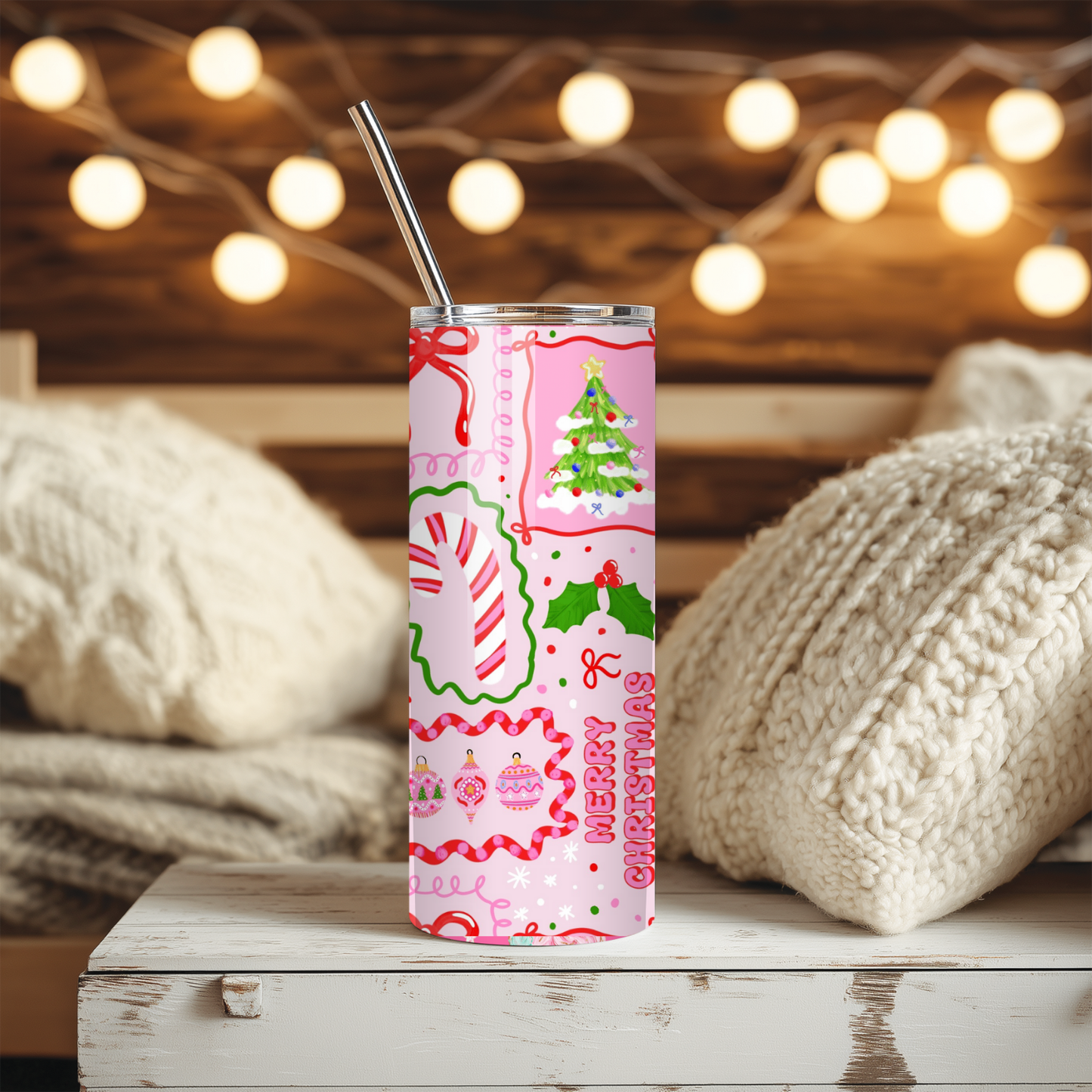 Christmas-themed tumbler with a pink design on a wooden surface with soft lighting in the background.