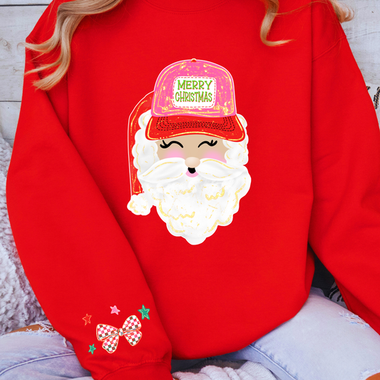 Red sweatshirt with a cartoon Santa Claus face wearing a pink 'Merry Christmas' hat.