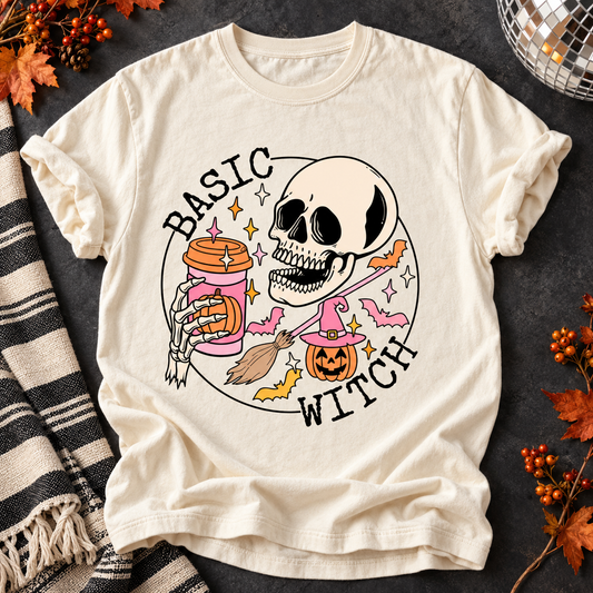 Ivory Basic Witch T-shirt with skeleton holding a pumpkin spice drink on a fall flat lay