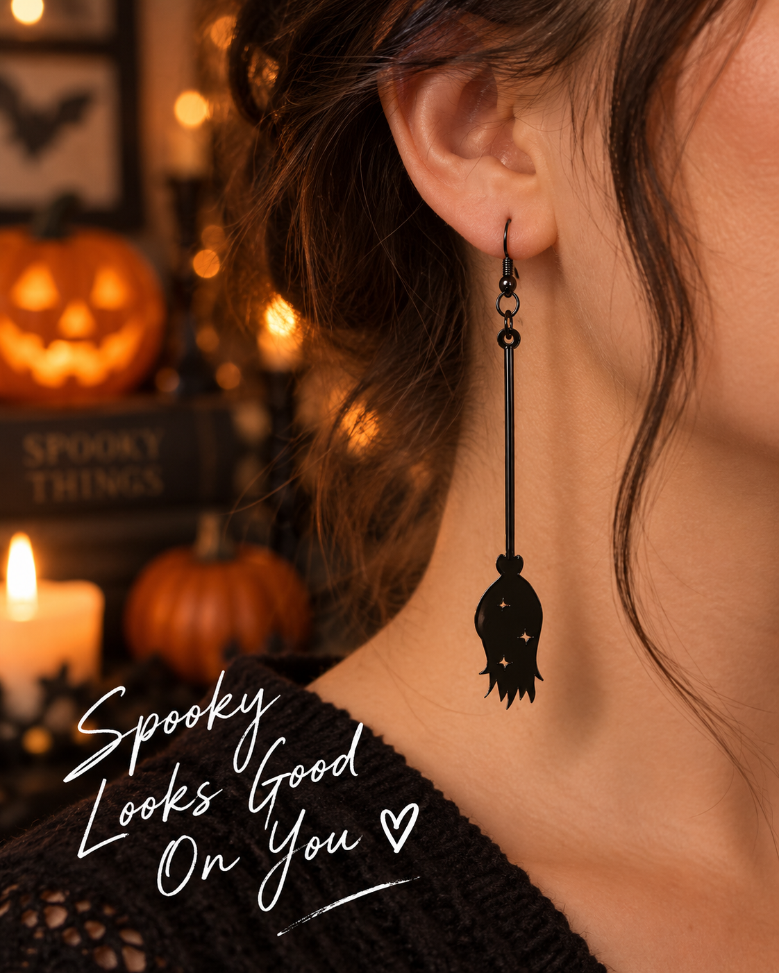 Black spooky dangle earring worn on ear