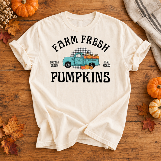 Ivory T-shirt featuring Farm Fresh Pumpkins vintage truck graphic on an autumn flat lay