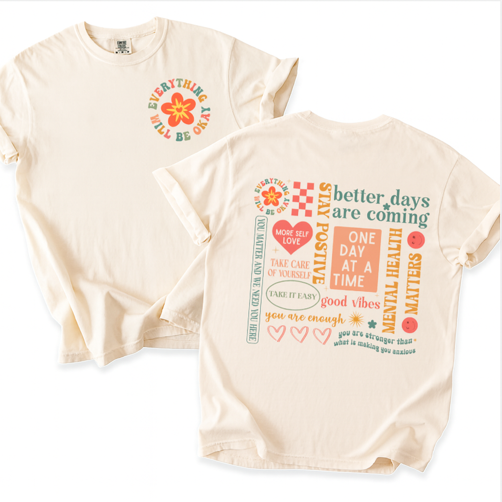 Two cream-colored t-shirts with motivational phrases and graphics on a white background