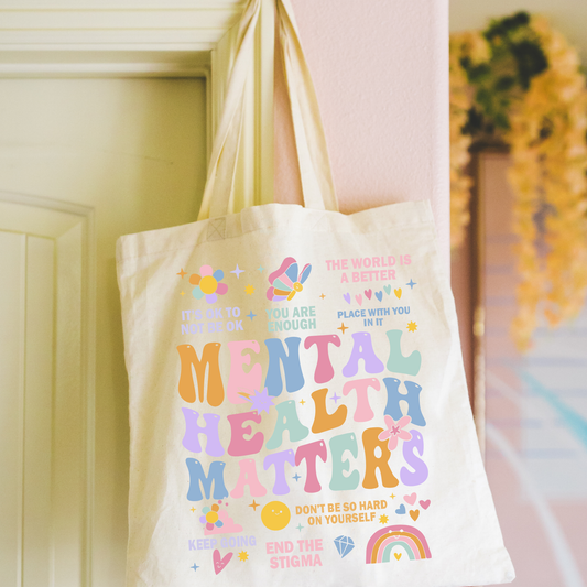 Tote bag with 'Mental Health Matters' message hanging on a door