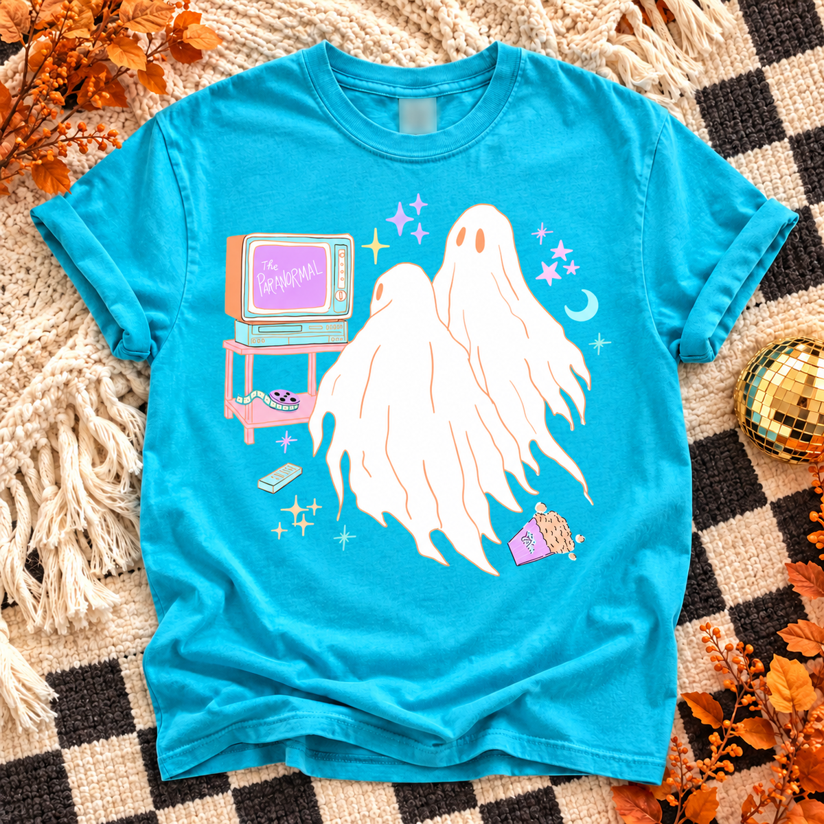 Lagoon T-shirt with three white ghosts beside a pastel retro TV labeled The Paranormal