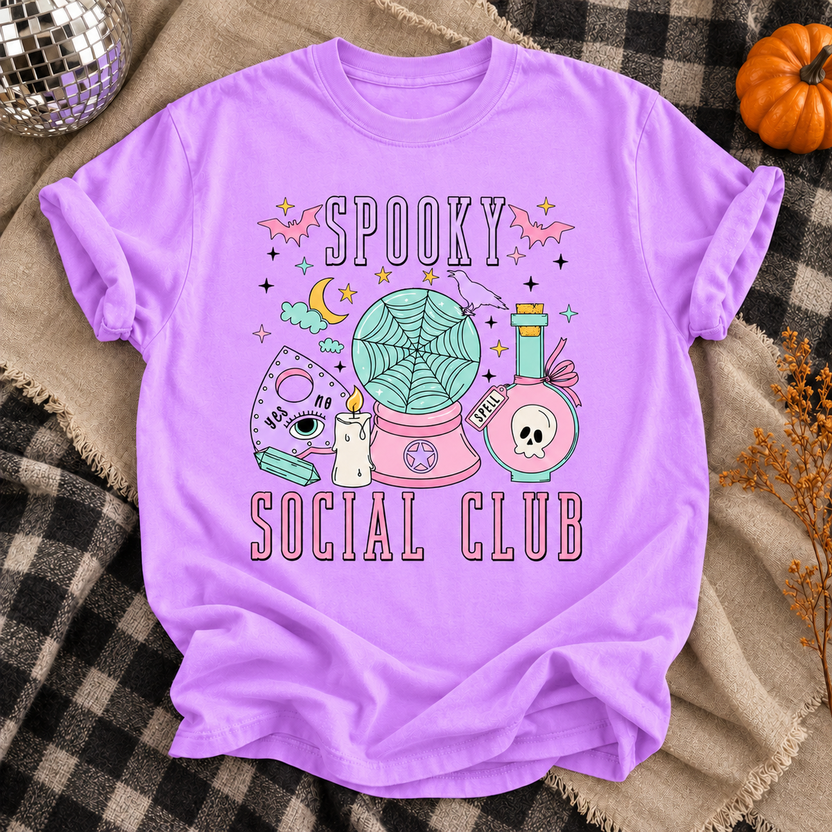 Neon Violet Spooky Social Club T-shirt with pastel ghost radio and Halloween details on a checkered throw