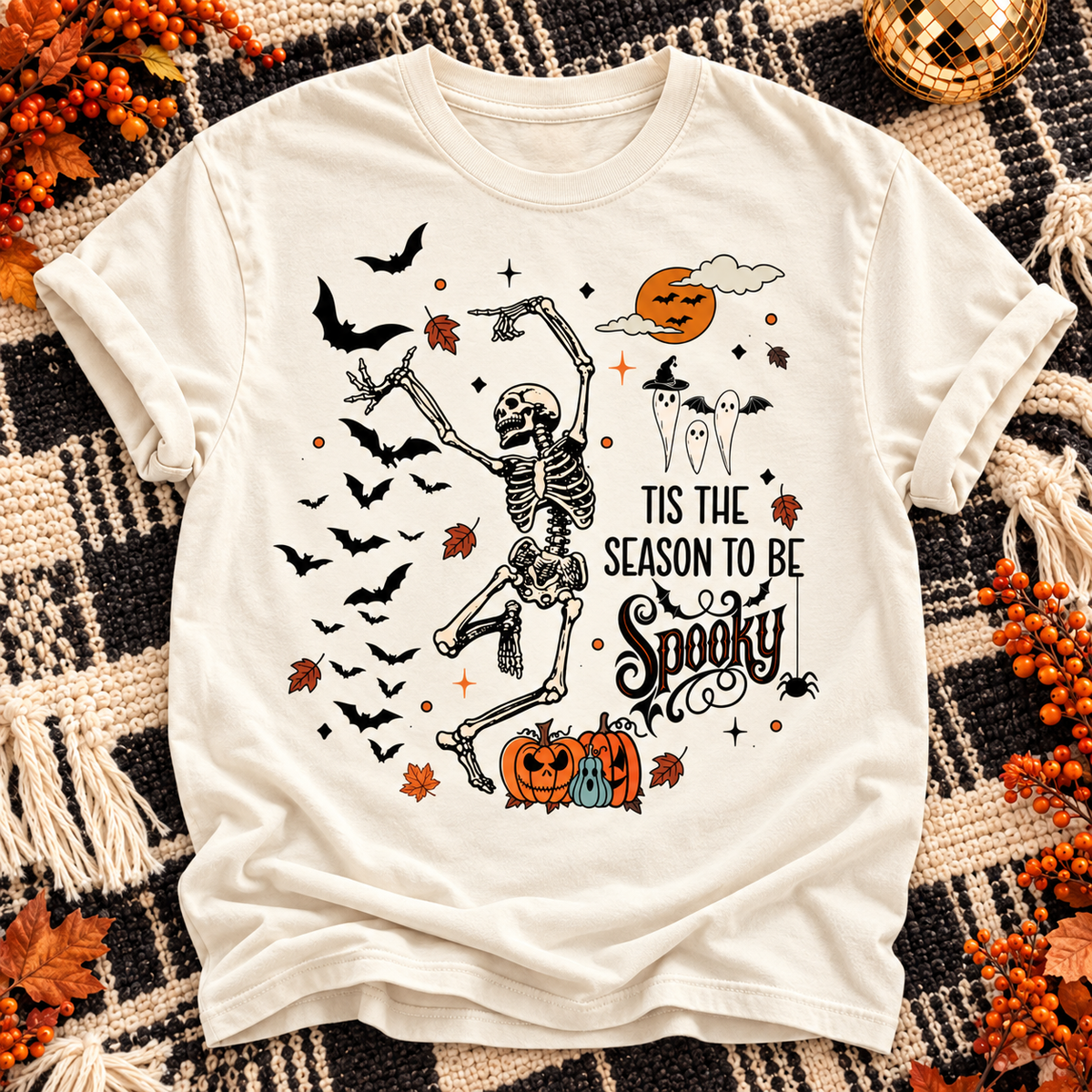 Ivory T-shirt with dancing skeleton, bats and pumpkins, 'Tis the Season to Be Spooky design