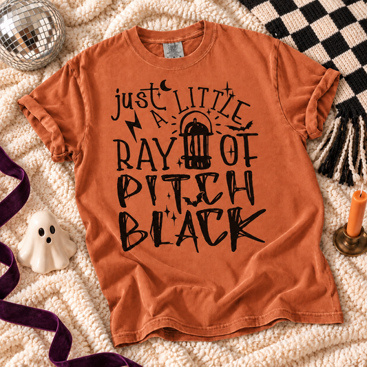 Yam T-shirt featuring Just a Little Ray of Pitch Black graphic on a cozy fall flat lay